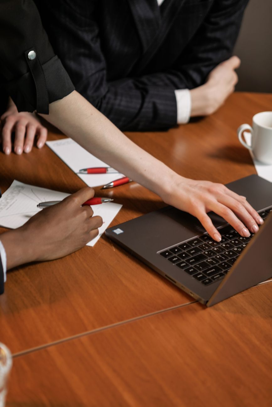 People working together around a laptop